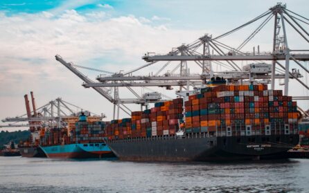 Busy port with large ship full of shipping containers