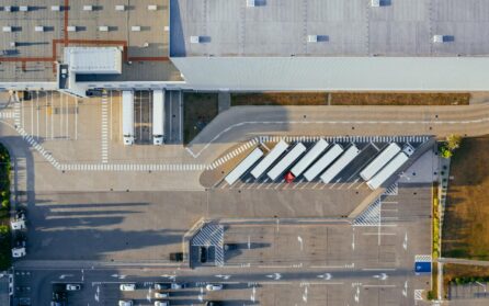 Overhead view of shipping warehouse with trucks in parking lot